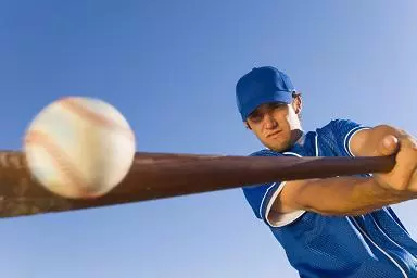 player hitting baseball